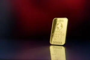 100 gram gold bar on a red background